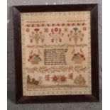 A 19th century woolwork sampler in rosewood frame. With a religious verse flanked by fruit baskets