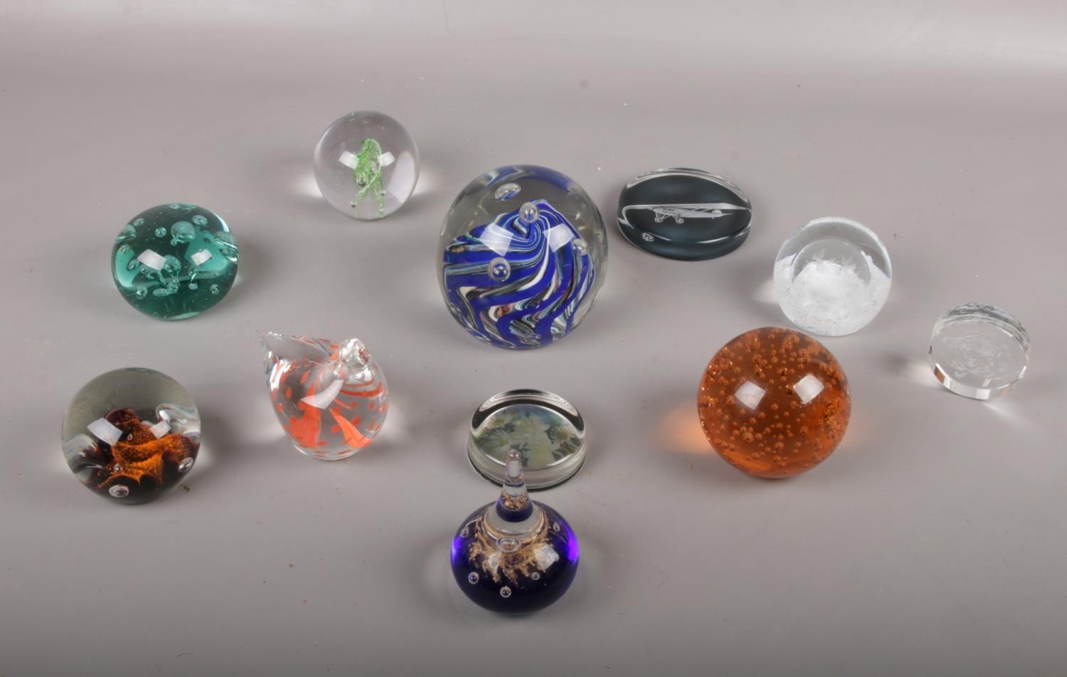 A collection of paperweights, various colours and sizes