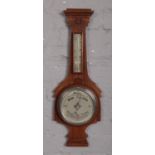 A mahogany banjo wall barometer with silvered dial.