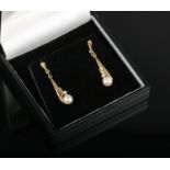 A pair of cased 9ct gold pearl and diamond pendant earrings.