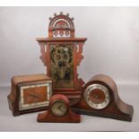 A Seth Thomas gingerbread clock, along with three mantle clocks. Gingerbread clock in need of