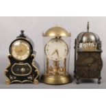 A German brass torsion clock in glass case, A Kern tosion clock in ebonized French style case and