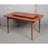 A Greaves & Thomas teak extending dining table with extra leaf.
