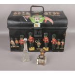 A metal trunk decorated with commemorative artwork to include glass scent bottle and ink well