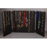 A tryptic jewellery display stand and quantity of costume jewellery beads.
