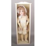 An Armand Marseille 390 doll with original clothes and wig in wooden display case.
