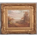 A 20th century English school gilt framed oil on board. River landscpae with a figure mooring a boat