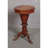 A Victorian inlaid walnut centre pedestal work table, 78cm high. One leg re glued. Two strips of