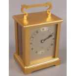 A brass cased Elliot anniversary clock with open platform escapement, dial marked John Mason.