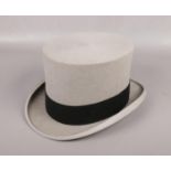 A gentleman's grey felt top hat with black band. Label for Moss Bros, Covent Garden. Size 7 1/4.