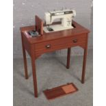 An electric Jones sewing machine on work table.