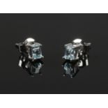 A pair of 9ct white gold ear studs set with pale blue baguette cut gemstones.