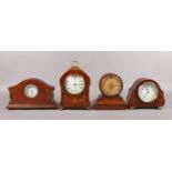 Four Edwardian mahogany and walnut cased mantel clocks, some inlaid and with French movements.