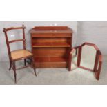 A yew wood open bookcase along with a mahogany bergere seat bedroom chain and a triple mirror.