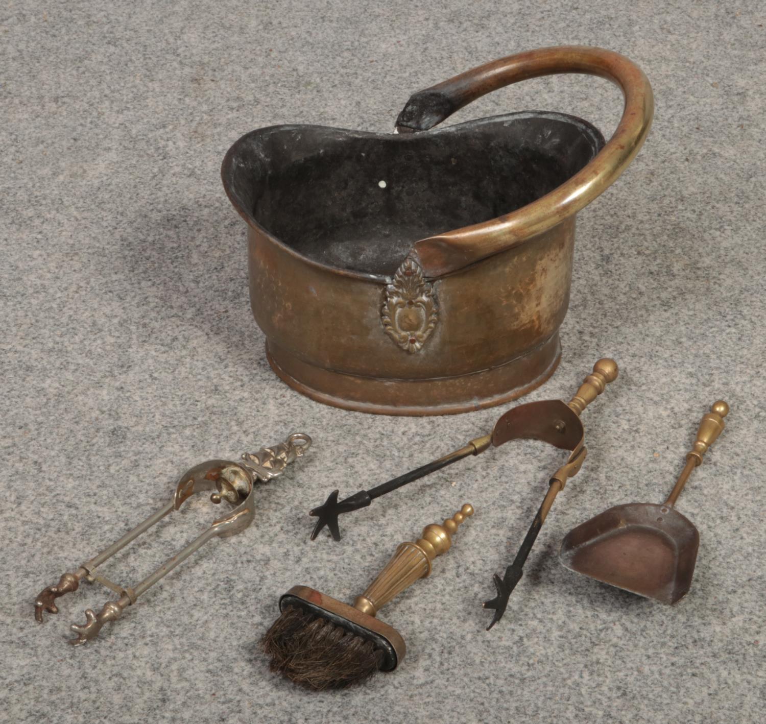 A brass coal helmet / scuttle and collection of fireside tools.