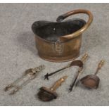 A brass coal helmet / scuttle and collection of fireside tools.