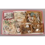 A tray of vintage costume jewellery including white paste, gilt chains and a collection of stick
