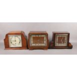 Three 8 day mantel clock with Westminster chime. Two oak cased including Garrard and a walnut