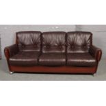 A vintage G Plan teak and upholstered saddle sofa, in the manner of Kofod Larsen, raised on chrome