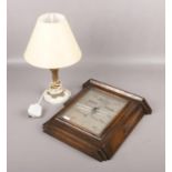An Art Deco oak framed barometer by Carmichaels of Hull and a gilt metal tablelamp raised on an
