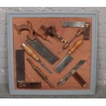 A framed display of vintage tools, to include Joseph Marples.