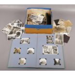 A box of photographs along with a scrap book of mainly monochrome photographs and postcards of