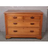 A mahogany 2 over 2 chest of drawers. Splits to wood at each side.