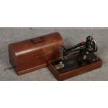 A dome top oak cased singer sewing machine.