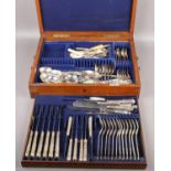 An Elkington & Co oak cutlery canteen with contents of various part sets, to include Walker &