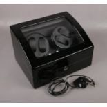 A lockable electric automatic watch winder.