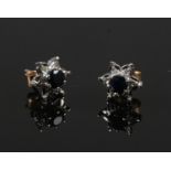 A pair of 9ct gold, sapphire and diamond floriform cluster ear studs. One stone lacking.