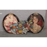 Two oval parcel gilt picture frames, along with a decorative metal America sign.