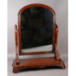 A Victorian mahogany toilet mirror. Raised on carved scroll supports, 74cm. Some veneer chips.