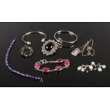 A quantity of silver jewellery including a glass filled ruby bracelet, large jet pendant / brooch