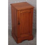 A Victorian satinwood pot cupboard.