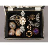 A jewellery box with contents of costume brooches, including vintage examples.