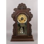 An Ansonia Clock company gingerbread automatic alarm clock with ting tang chime, 58cm.