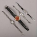 Three ladies silver watches, along with a Franklin Mint Monte Carlo Casino watch.
