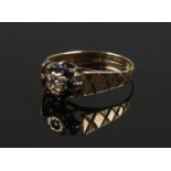 A 9ct gold, sapphire and diamond cluster ring with chased shoulders. Size M.