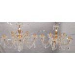 A pair of glass droplet brass chandeliers.