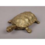 A Victorian novelty cast brass inkwell modelled as a tortoise, the hinged brass carapace opening