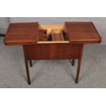 A Mahogany fitted sewing table with spring loaded mechanism ( approximately 63 cm x 38 cm)