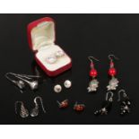 Seven pairs of silver earrings including a pair of moissanite cluster ear studs.