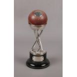 A George V silver cricket trophy. Formed from a Gunn & Moore cricket ball with silver plaque