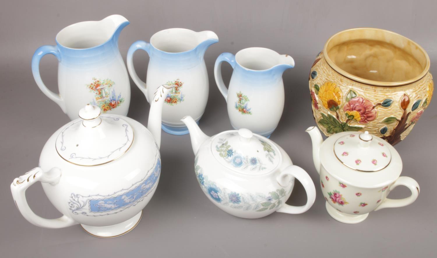 A group of ceramics to include Wedgwood, Royal Doulton, three Newhall graduated jugs, Coalport etc