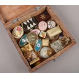 A wooden box of various pill boxes.