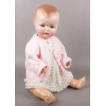 A German bisque head doll, open mouth with two bottom teeth showing, with bent limbed composition