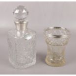 A cut glass decanter with silver collar, and silver sherry label, along with a silver rimmed glass