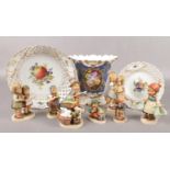 A collection of Goebel Hummel figures, along with two Meissen hand painted cabinet plates and a