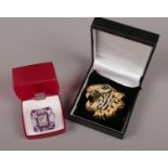 A yellow metal Butler & Wilson tiger brooch, along with a white metal paste set dress ring.